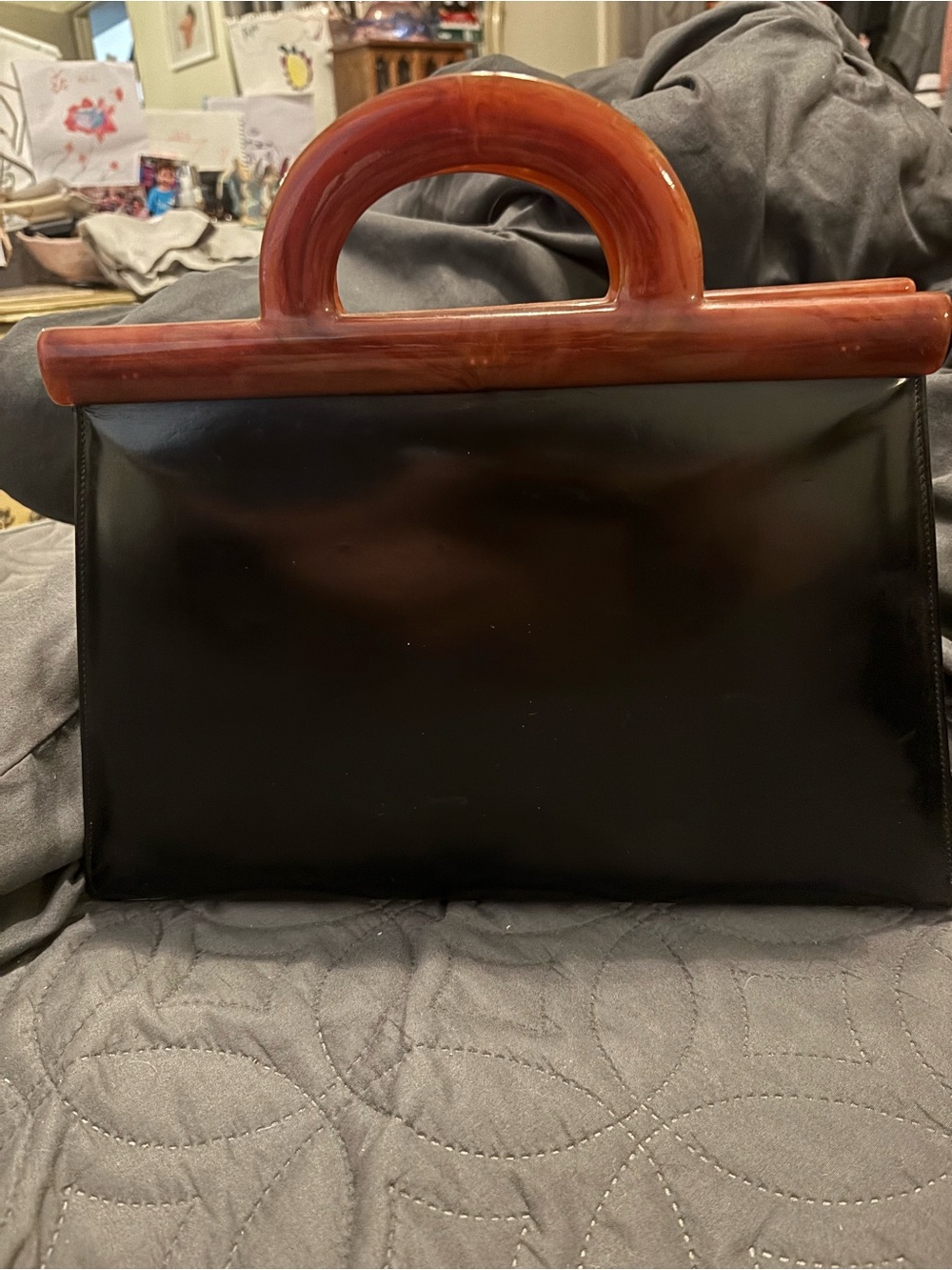 Sleek Black Patent Clutch with Brown Resin Top Handle